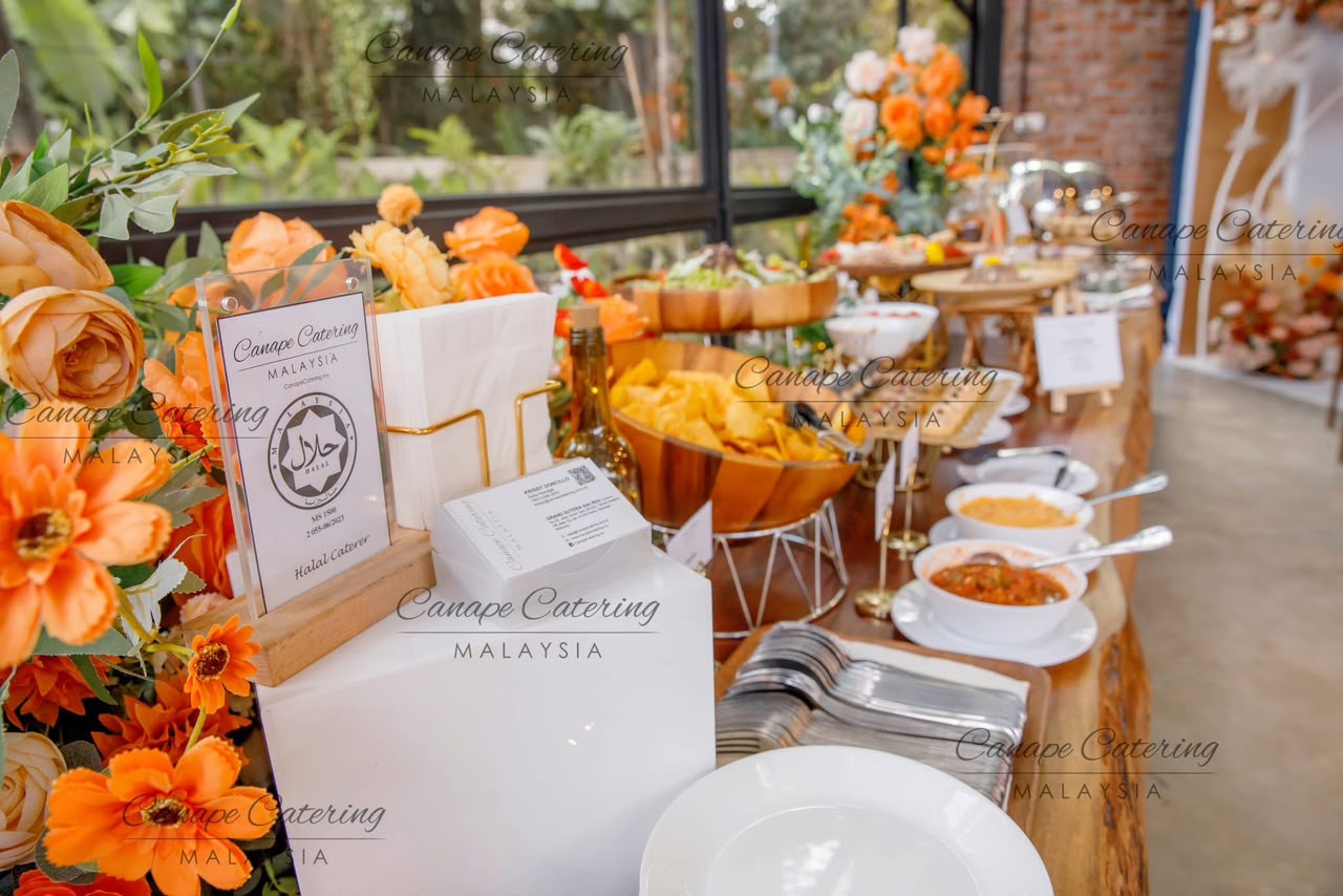 Canapé and dip spread styled with orange florals at an event